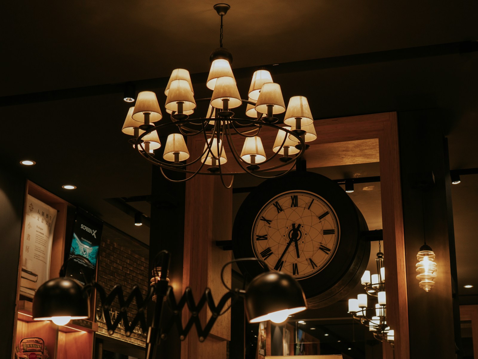 Elegant chandelier hangs above a vintage clock.