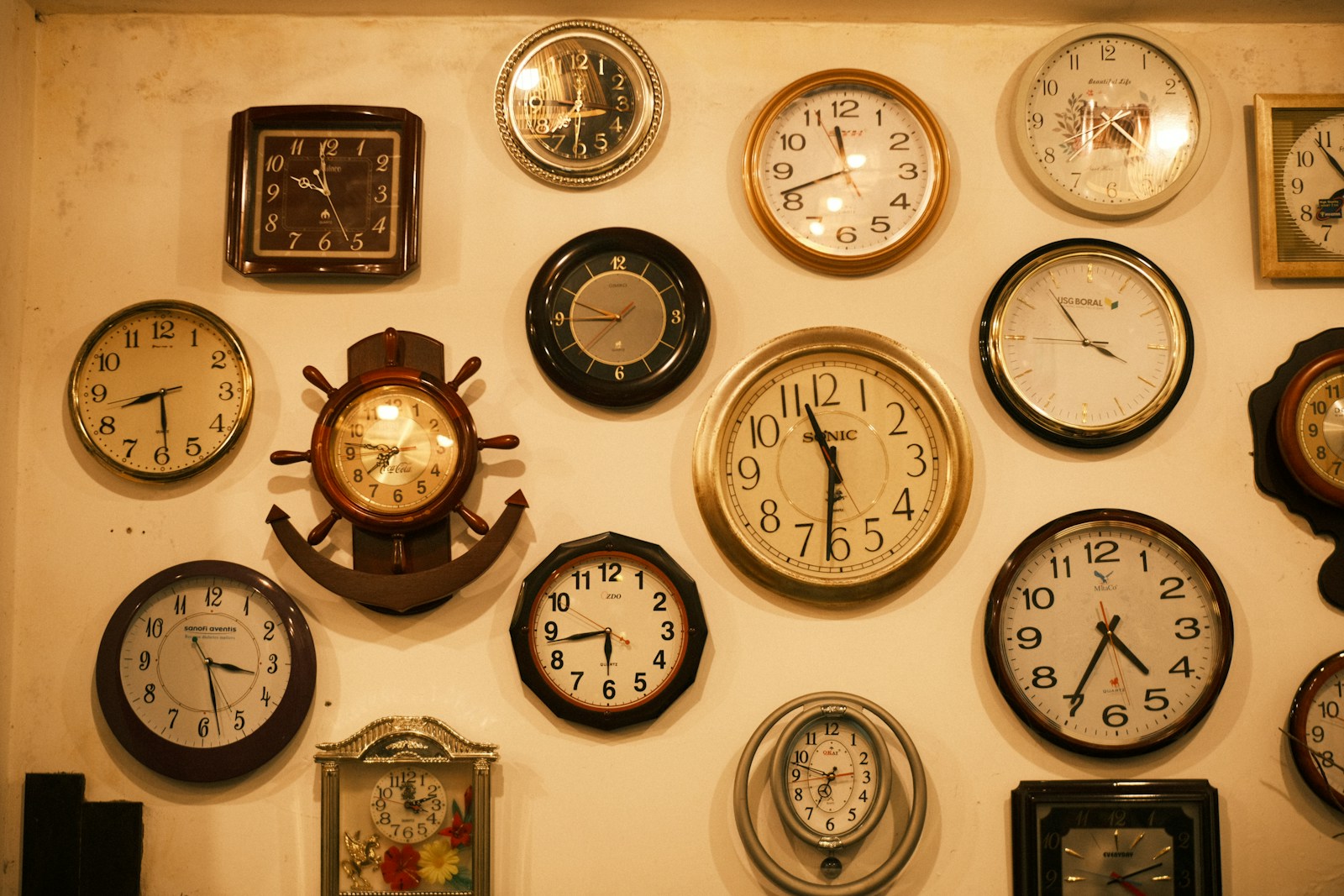a wall with many different clocks on it