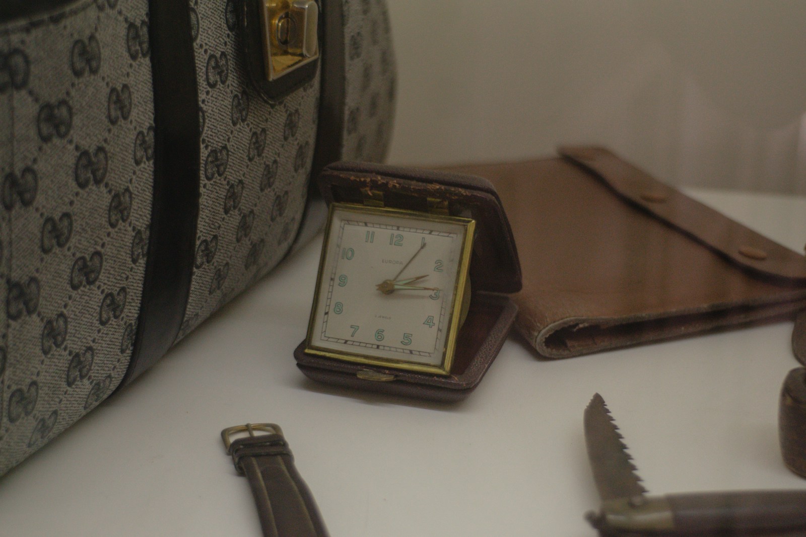 Vintage travel alarm clock with leather case and patterned bag